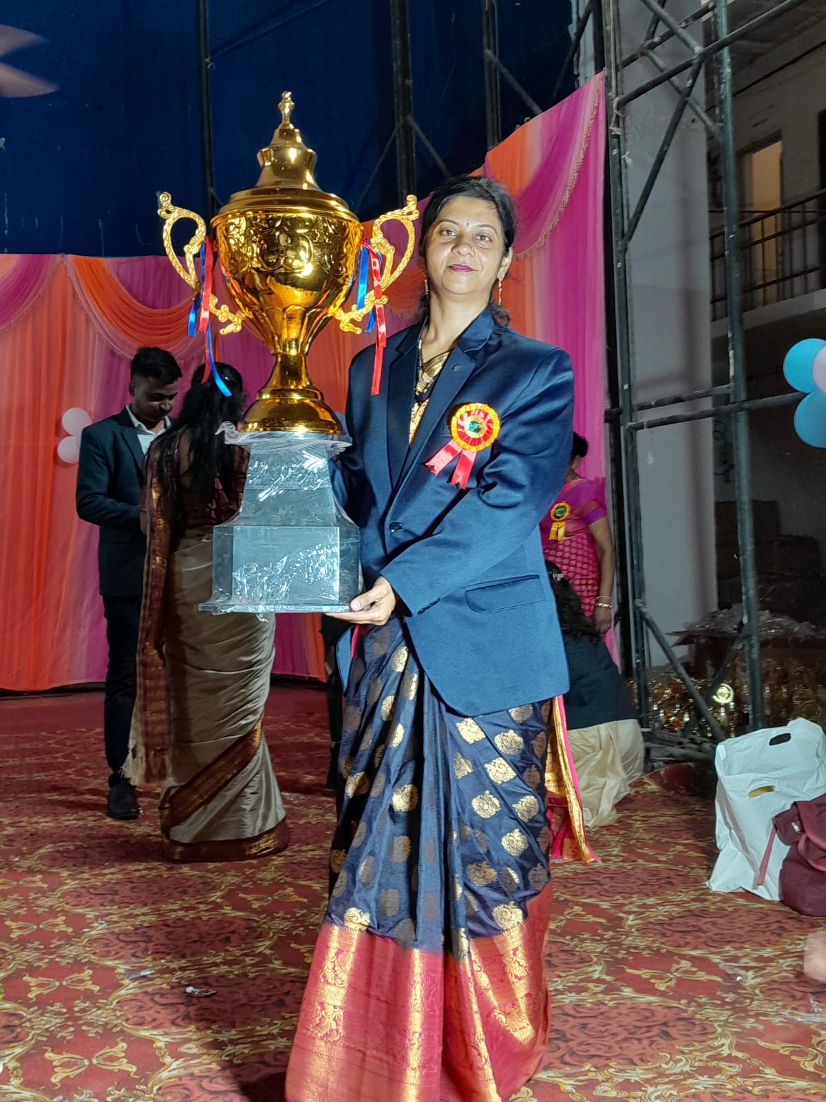 Mrs. Pooja Bakale Director Genius Kids Academy Wardha with Trophy